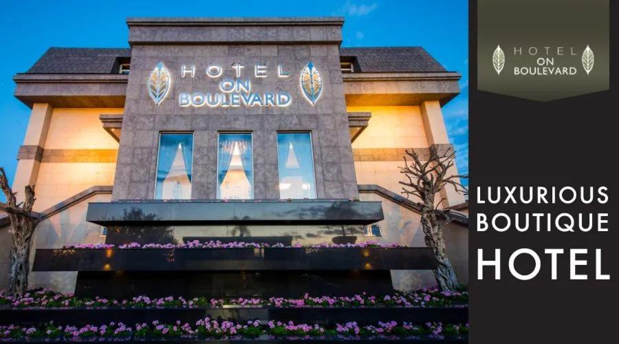 a building with a bunch of flowers in front of it at Hotel on Boulevard in Johannesburg
