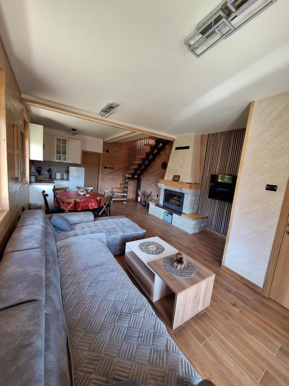 a living room with a couch and a table at Митровилица - Mitrovilica in Mitrovac
