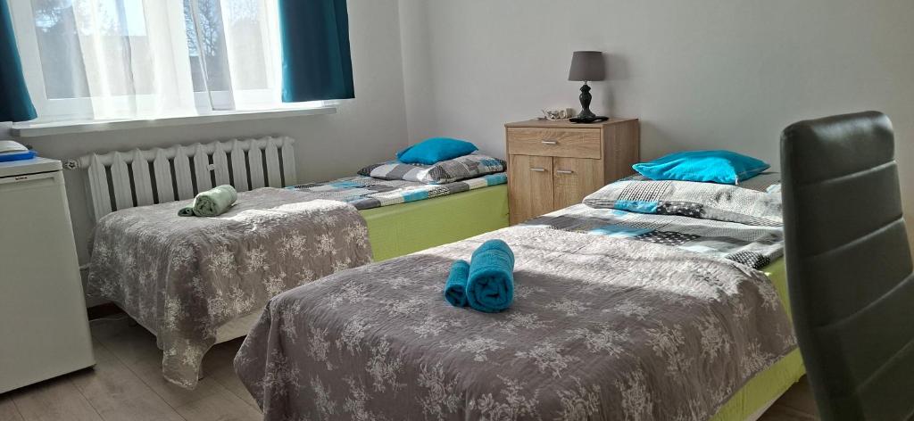 a room with two beds and a window and two beds sidx sidx sidx at Magma Grzybowo in Grzybowo