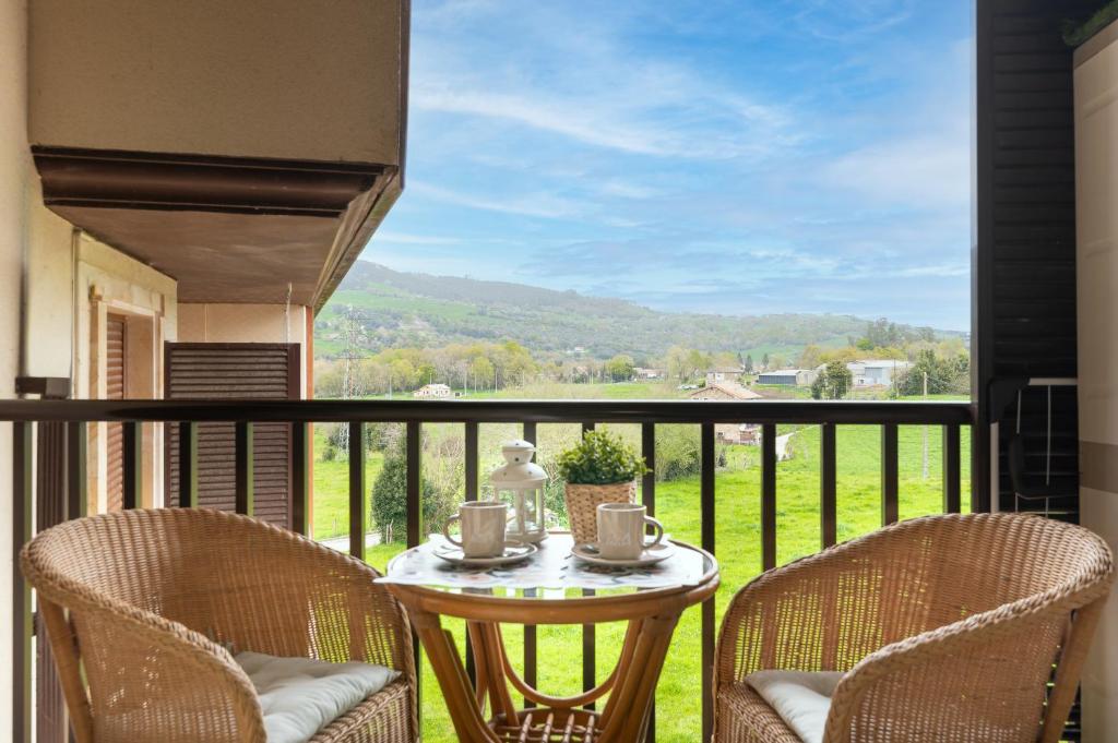 a table and two chairs on a balcony with a view at Apartamento en Bádames in Bádames