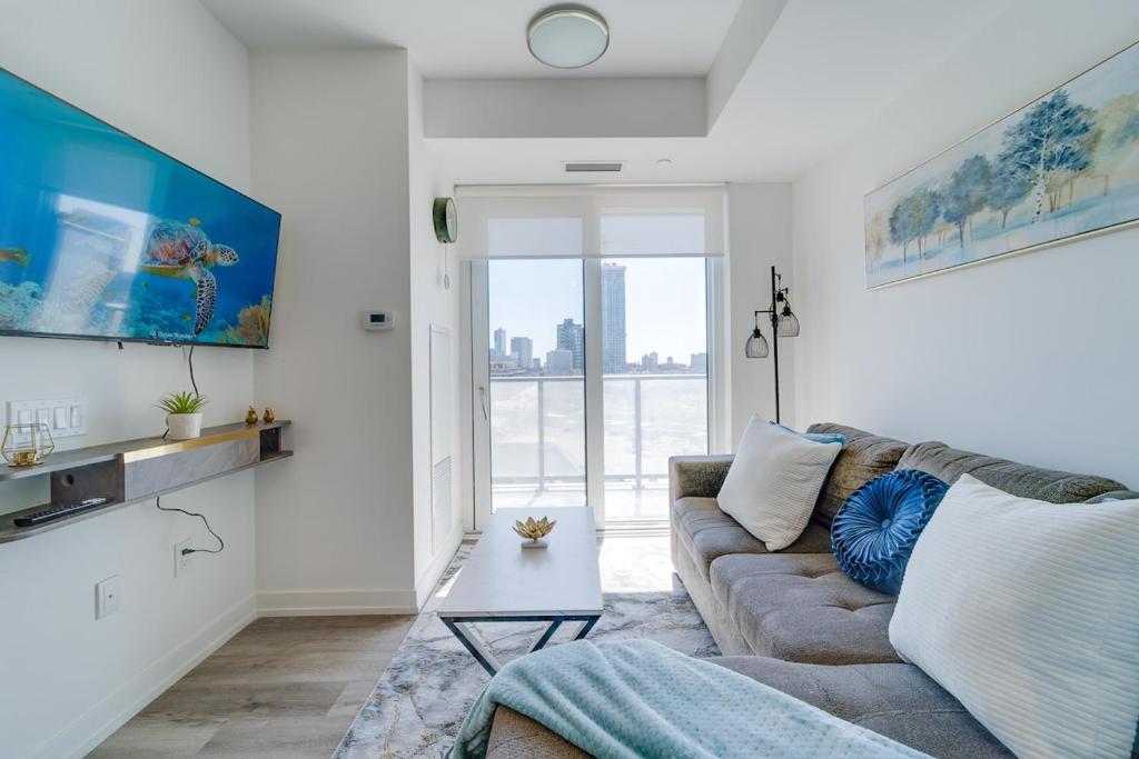 a living room with a couch and a table at Modern Downtown Condo with Gym in Kitchener