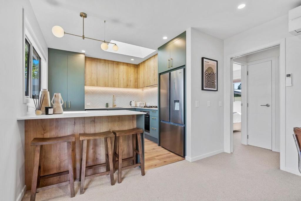 a kitchen with a wooden counter and a refrigerator at Renovation, location, relaxation in Twizel