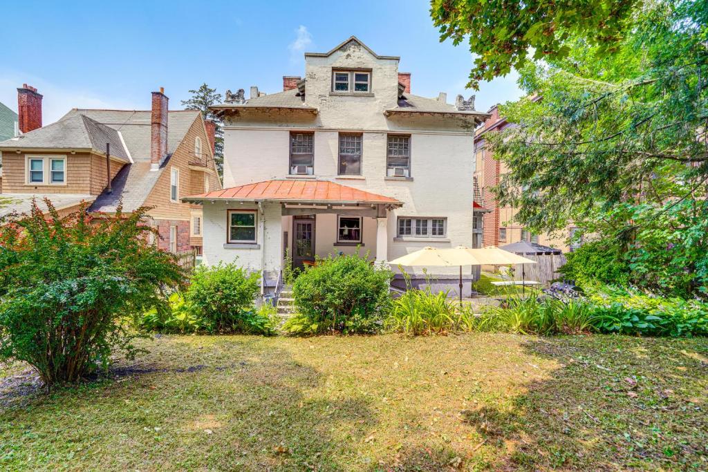 an old house with an orange roof in a yard at Walkable Schenectady Getaway: 2-Unit Campus Hub in Schenectady