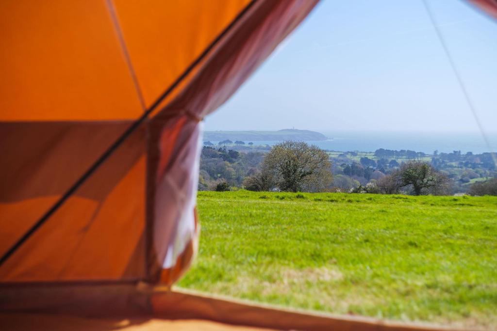 a view of a field from the inside of a tent at Boscoppa Farm-Furnished Bell Tent 4 in St Austell