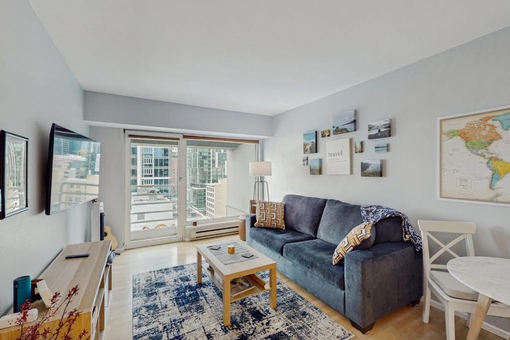 a living room with a blue couch and a table at My Place at Pike Place in Seattle