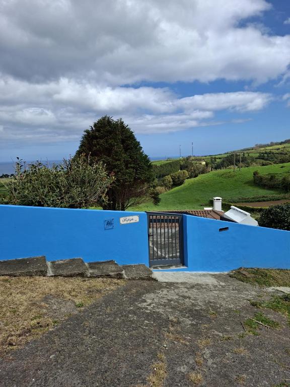 a blue wall with a gate on a hill at Home Near the Clouds - Refúgio in Nordeste