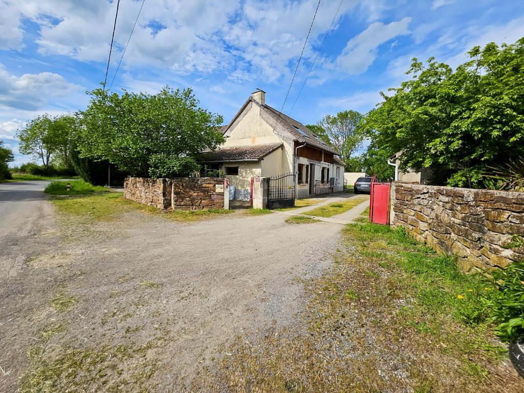 an old house with a stone wall and a street at La Maison des Jeux in Saint-Maur