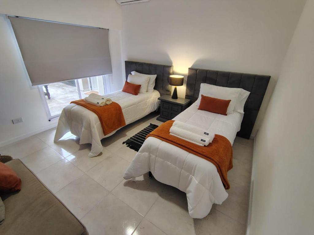 a bedroom with two beds and a window at CM Descanso boutique in Colorado River
