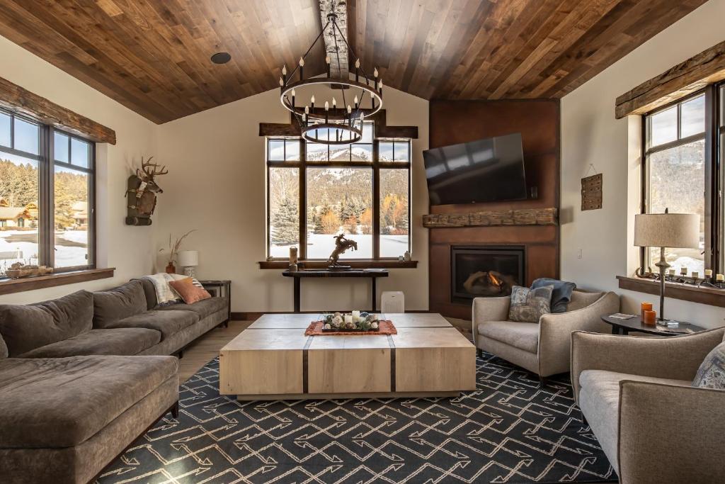 a living room with a couch and a table at Creekside Chalet in Big Sky