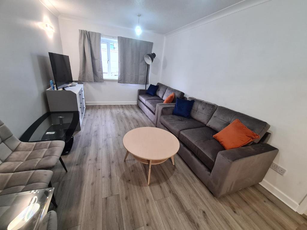 a living room with a couch and a table at Mailbox and Broad St in Birmingham