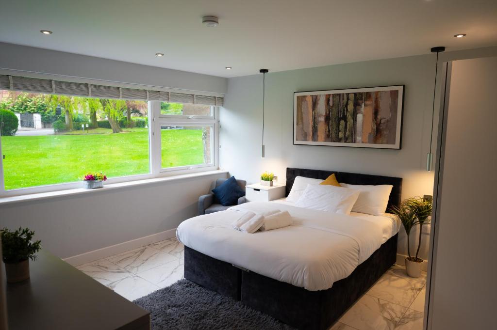 a bedroom with a large bed and a window at Westfield luxurious Apartment in Birmingham