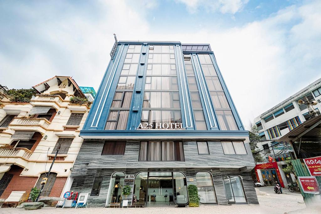 a tall blue building with a hotel sign on it at A25 Premium Hotel - 36 Giang Văn Minh in Hanoi