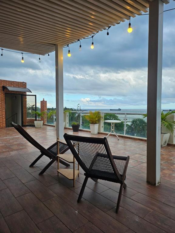 a patio with two chairs and a table with a view at Hotel La Llave del Mar Zona Colonial in Santo Domingo
