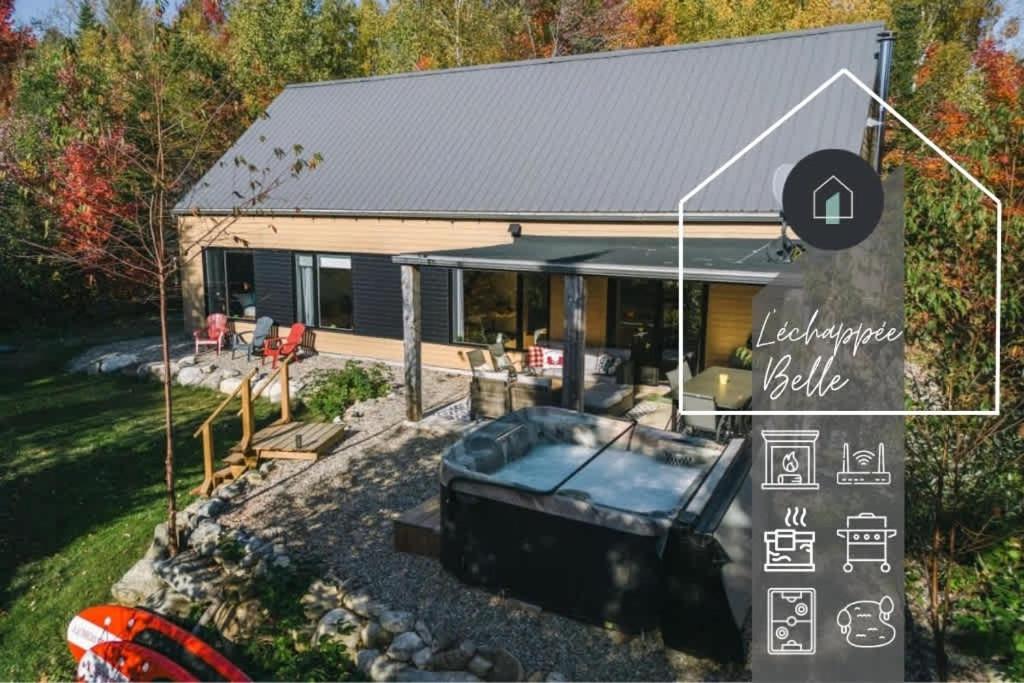 a house with a hot tub in the yard at L'Echappee Belle - lake and SPA in Saint Come