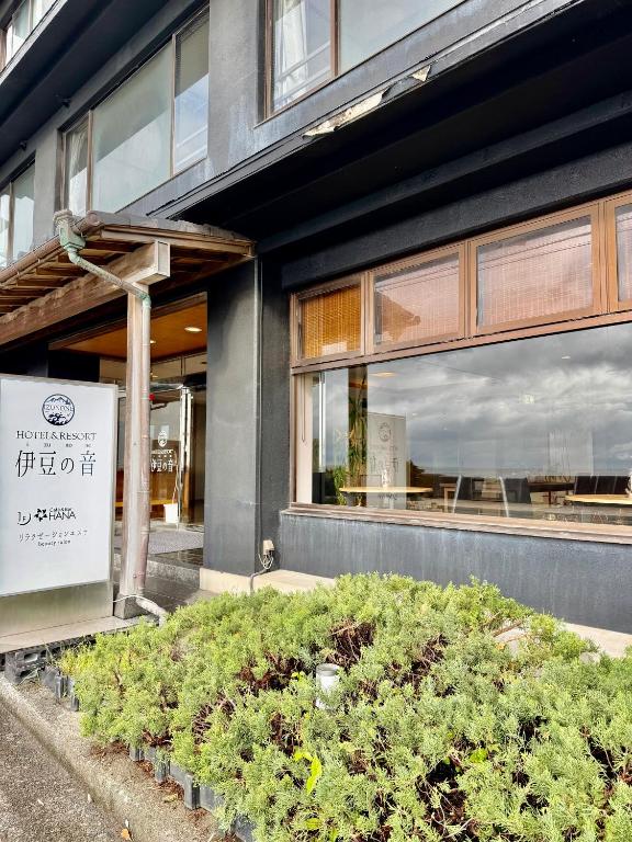 a building with a sign in front of it at HOTEL&RESORT Izu no Ne in Higashiizu