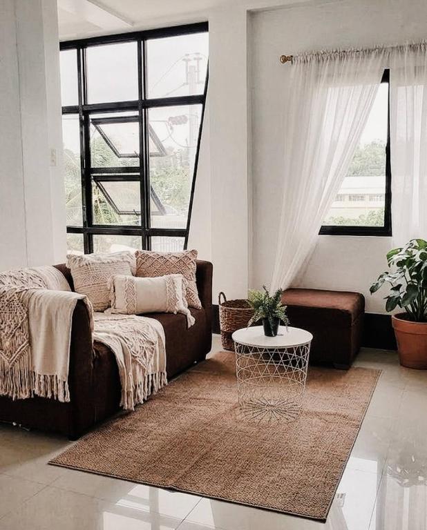 a living room with a couch and a table at El Kim Suites in Boac