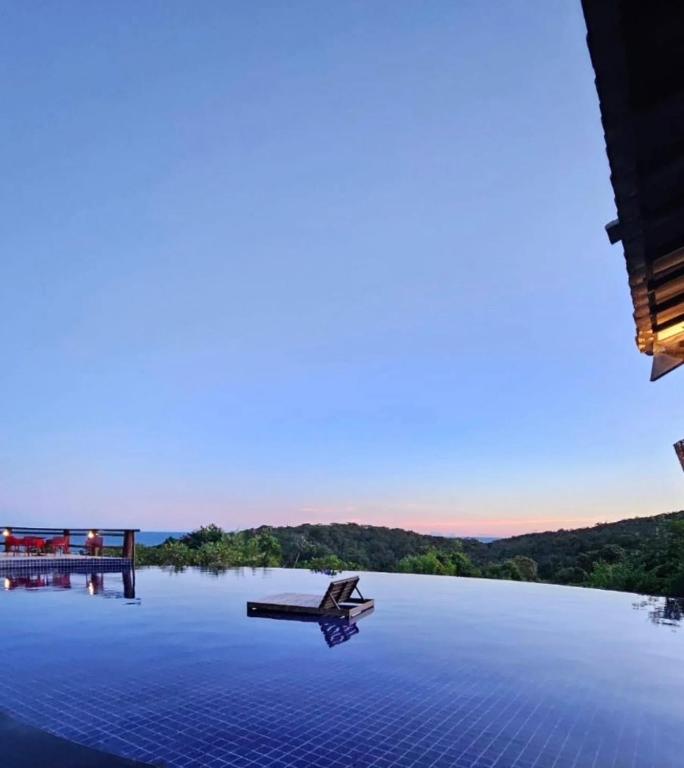 a view of a lake with a boat on the water at Villas do Pratagy Bambu 2 in Maceió