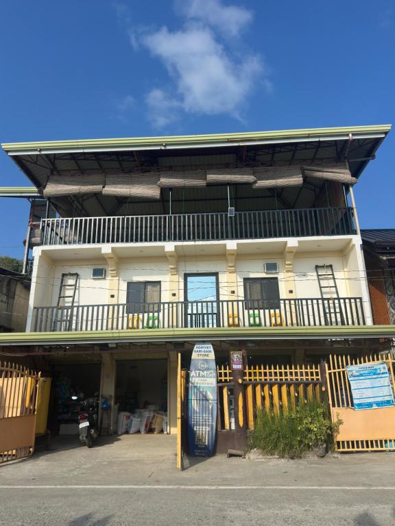 a building with a blue surfboard in front of it at Cris&Mar Homestay Extension in Burgos