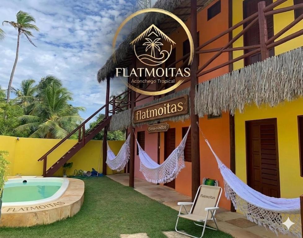 a resort with a hammock outside of it at Flatmoitas in Amontada