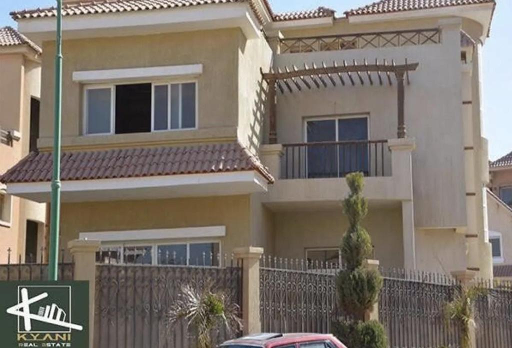 a house with a car parked in front of it at Katameya Palms in Cairo