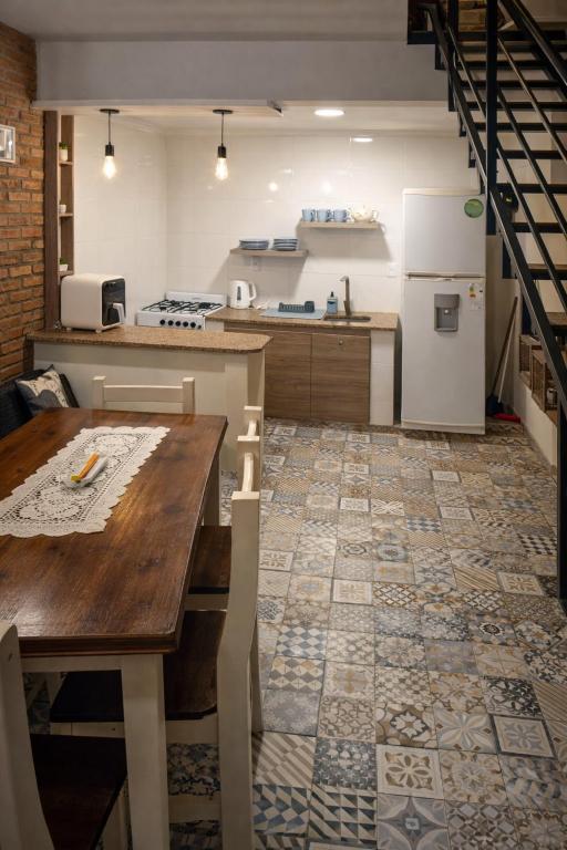 a kitchen with a wooden table and a refrigerator at Duplex Mi Lar in Termas de Río Hondo