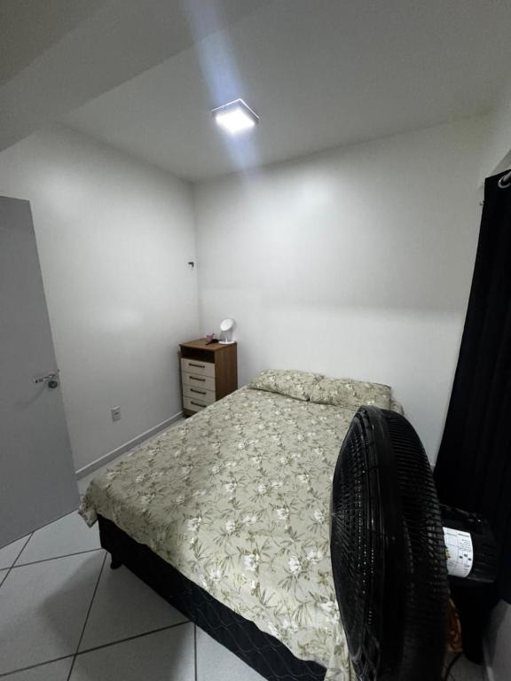a bedroom with a bed and a dresser in it at Ap FIG Garanhuns in Garanhuns