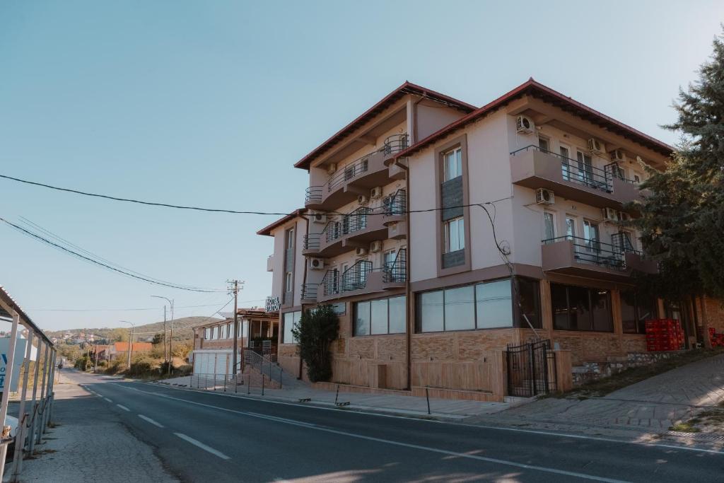 an apartment building on the side of a street at Hotel Istatov in Nov Dojran