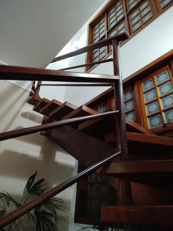 a wooden spiral staircase in a house at Hostel Terraço Urbano in Sao Jose do Rio Preto