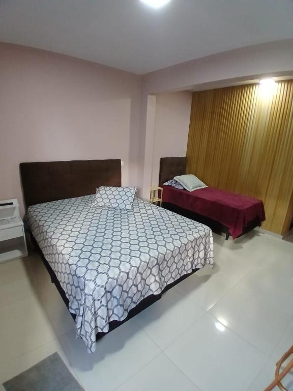 a bedroom with a bed and a bed sidx sidx sidx sidx at Pousada Santa Maria in Canoinhas