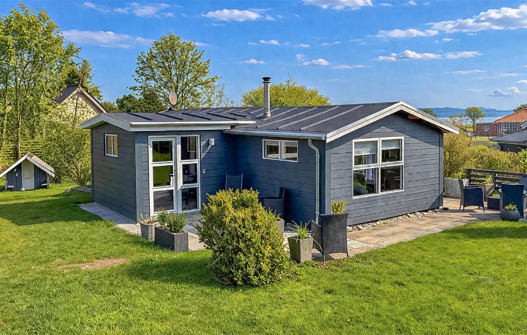 a blue tiny house in a yard at Nice Home In Broager With Wifi in Broager