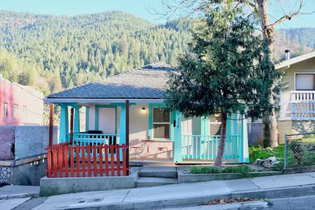 a small house with a red fence in front of it at Mt Shasta Basecamp in Dunsmuir