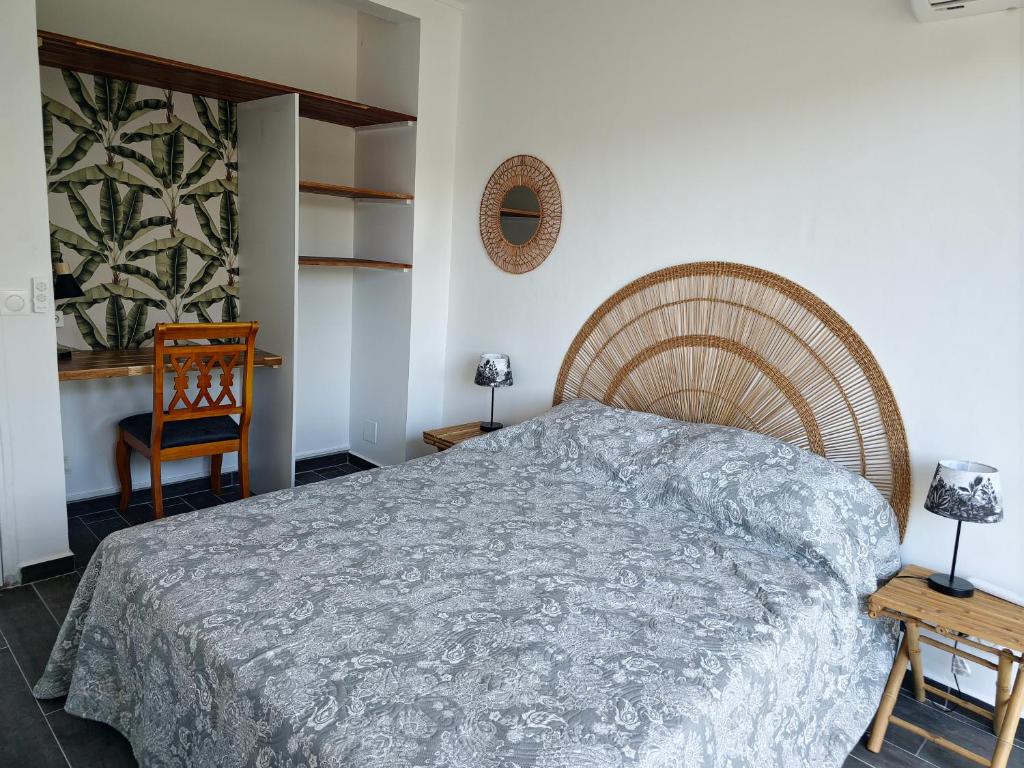 a bedroom with a large bed and a chair at L'Echappée Créole - Vue mer Terminal Ferry - Pointe-à-Pitre in Pointe-à-Pitre