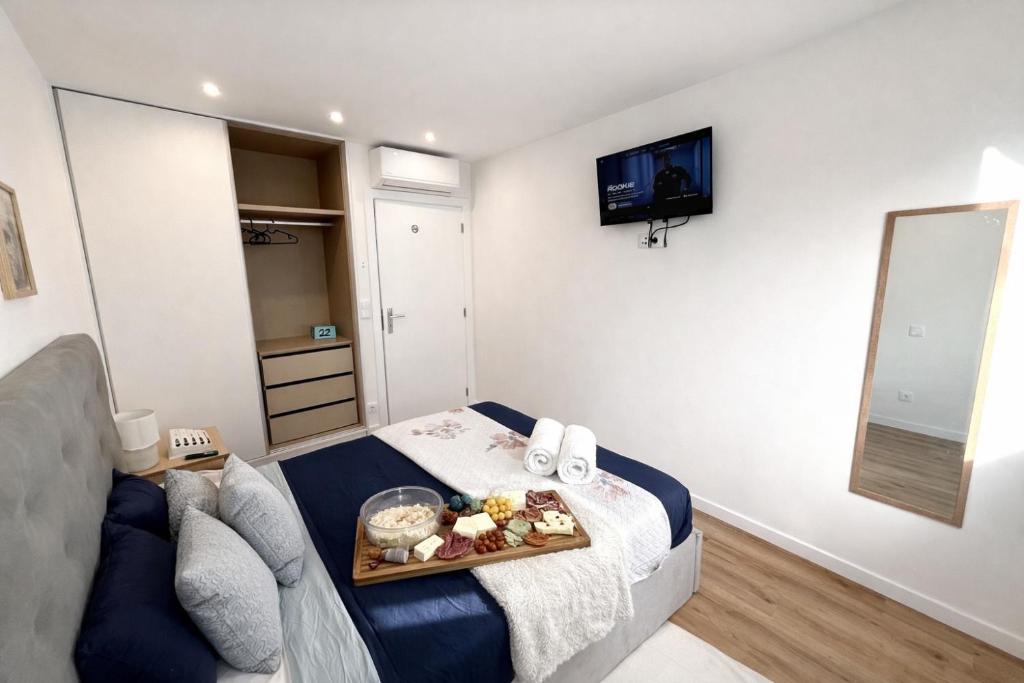 a living room with a tray of food on a bed at CC Room Gaia in Vila Nova de Gaia