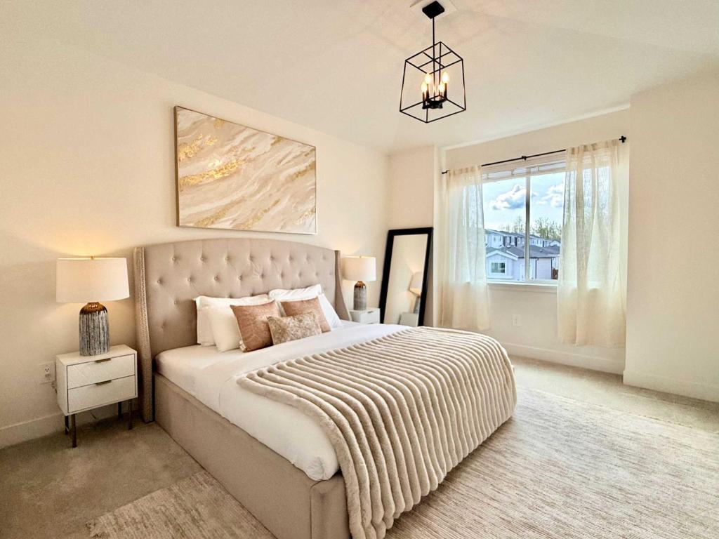 a bedroom with a large bed and a window at Luxury 3Br Oasis Gated Yard Pets Welcome in Langley
