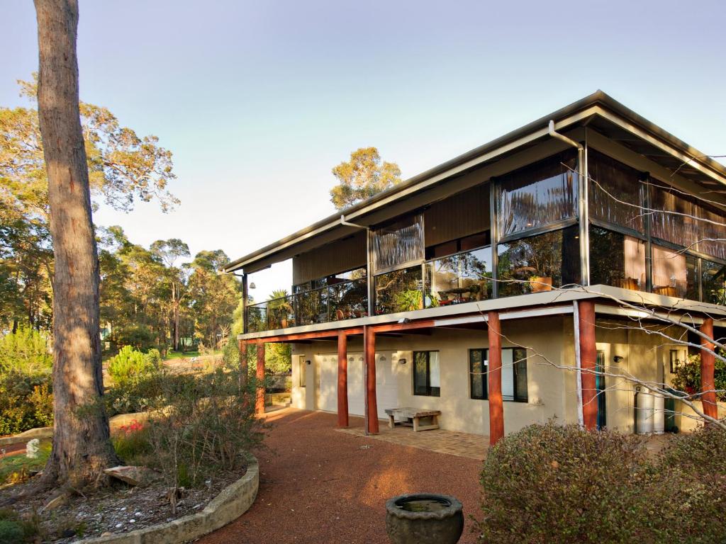 a large building with a tree in front of it at Waters Edge Margaret River Est 2010 in Margaret River Town