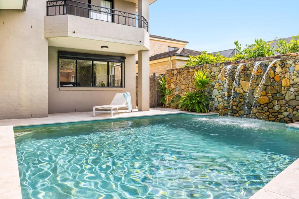 a swimming pool in the backyard of a house at Stone & Sand in Lennox Head