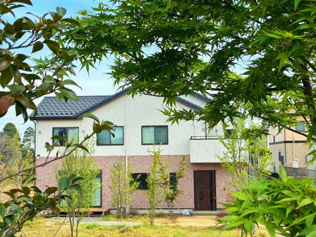a brick house with a black roof at Yume Terrace at Yachimata in Yachimata