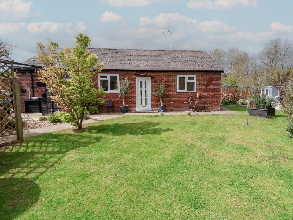 a brick house with a lawn in front of it at The Corner House in Woodbridge