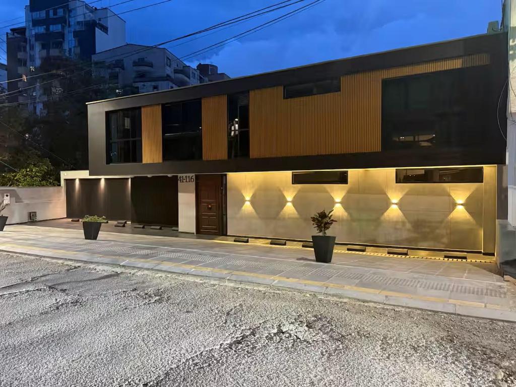 a building with two potted plants in front of it at LoftBrothers39 in Bucaramanga