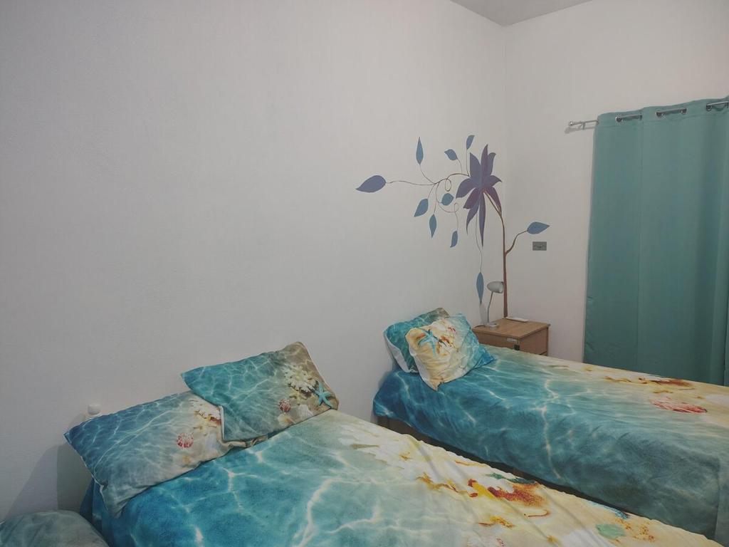 a bedroom with two beds with pillows on them at Arcadia 1 in Santiago