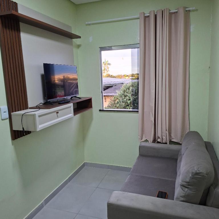 a living room with a couch and a window at Apartamento Selva in Itaquatiara