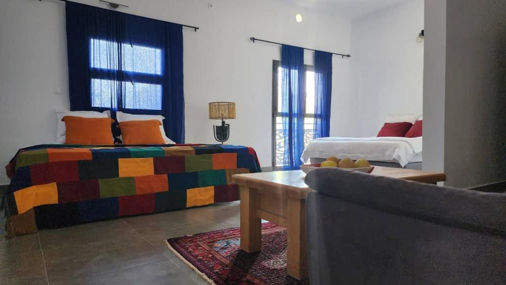 a living room with two beds and a couch at Suñu Tool Private Farm Guesthouse in Sindia
