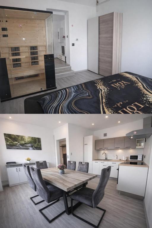a kitchen and a dining room with a table and a bed at Tabor View Apartment with sauna-Free parking in Maribor