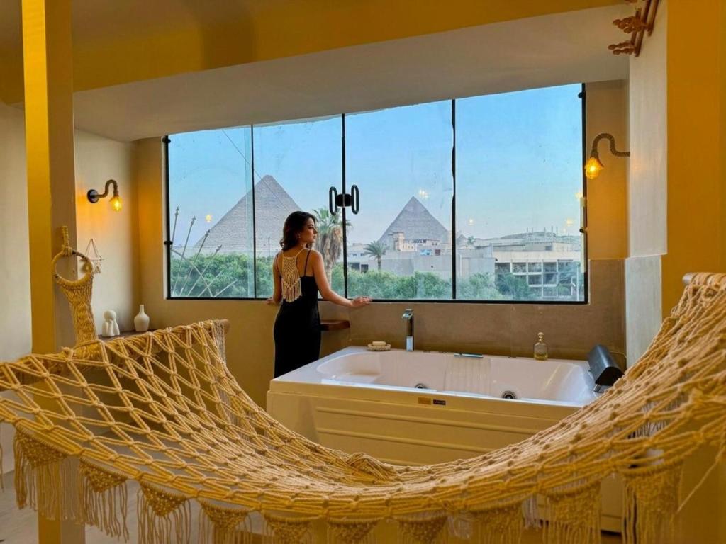 a woman standing in front of a bathroom mirror at nirvana pyramids view in Cairo