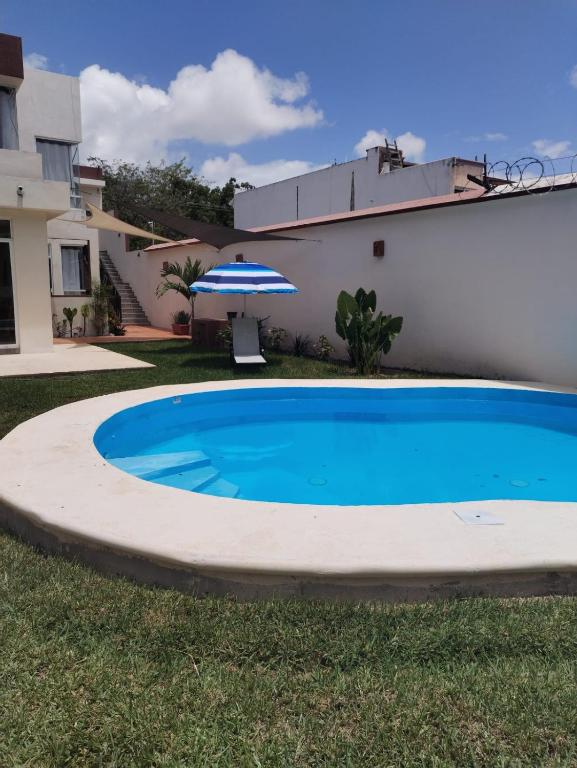 a swimming pool in the yard of a house at Villas Carlota Cancún in Cancún