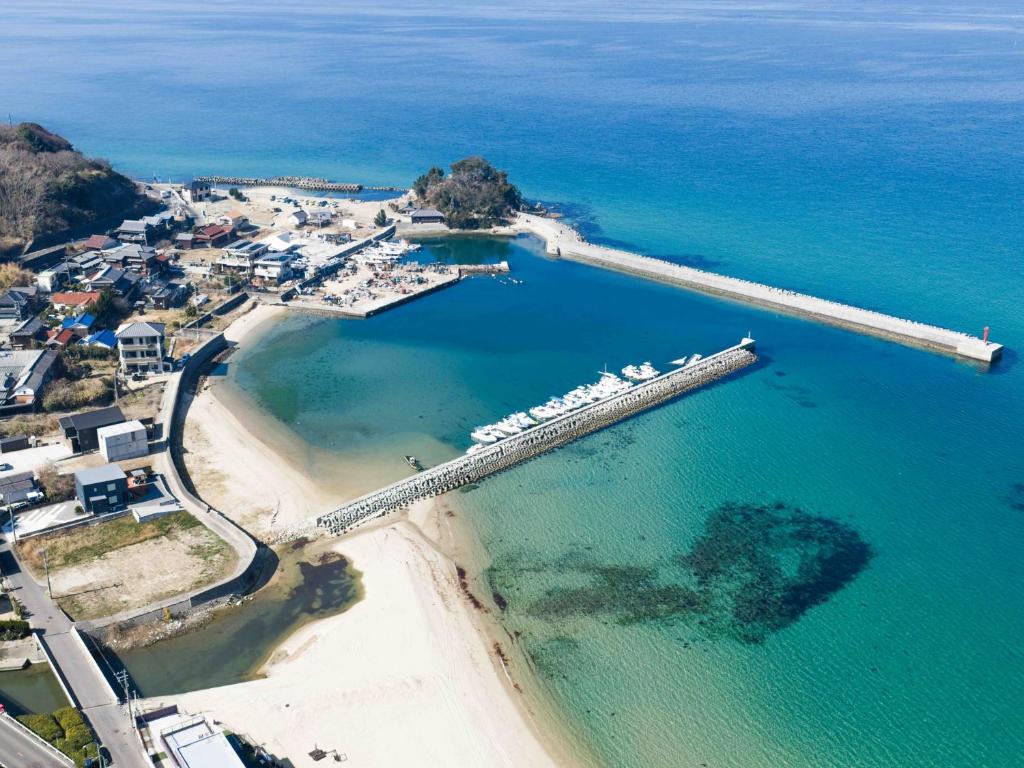 an aerial view of a beach with a dock at Private Ocean Resort YUUNAGI in Awaji