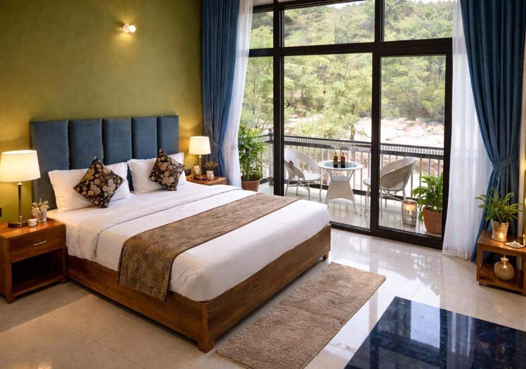 a bedroom with a large bed and a balcony at Hotel MountMemory , Barkot-Yamunotri in Barkot