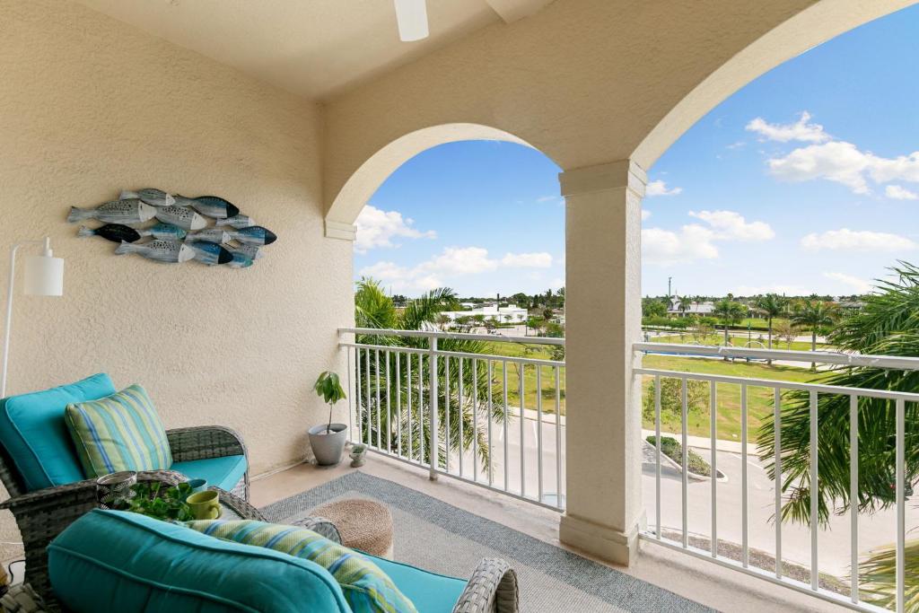a balcony with a couch and a view of the ocean at Spacious Condo - 2 King Suites - Close to Beaches in Marco Island