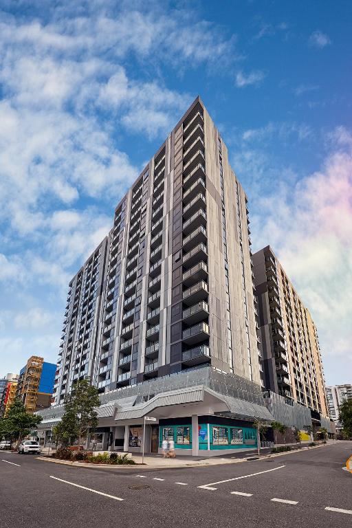 a large tall building with a street in front of it at King Street Residences in Brisbane