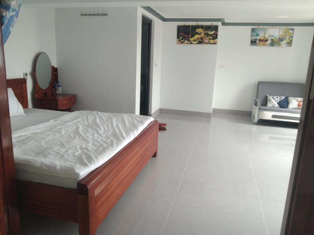 a bedroom with a bed and a mirror on the wall at Flamingo ibza001 in Thanh Hóa